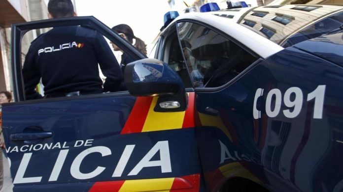 Agentes de la Policía Nacional junto a un coche patrulla